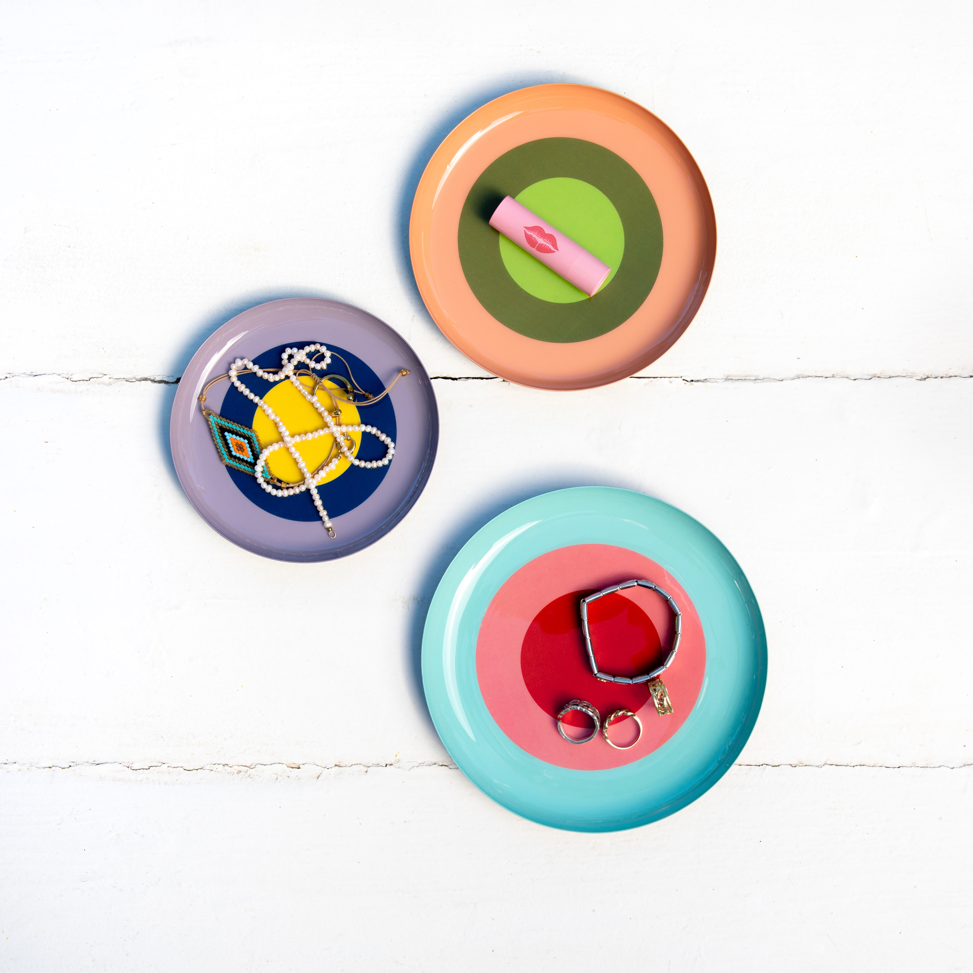 Set de trois coupelles rondes : orange avec un cercle vert, turquoise avec un cercle rouge, violet avec un cercle jaune.